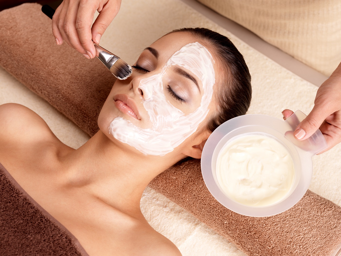 Spa therapy for young woman receiving facial mask at beauty salon in Cincinnati OH | Clear Eyes + Aesthetics